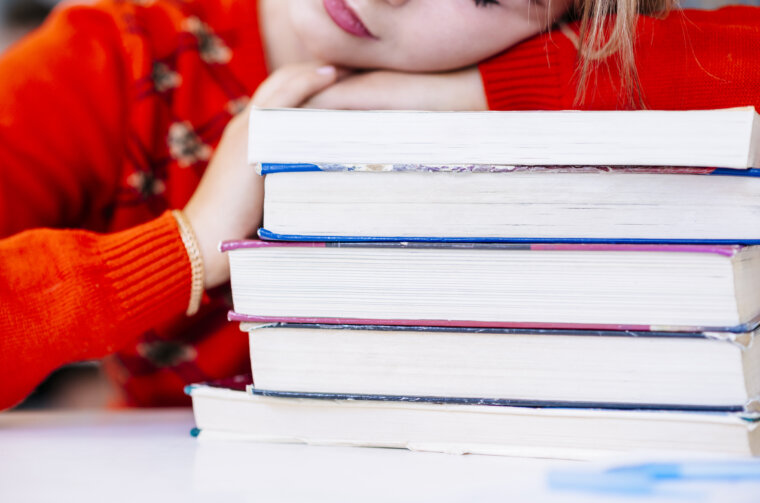 student-laying-books-table